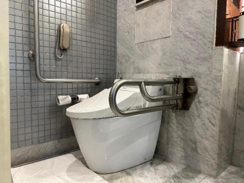 a white toilet in a bathroom with a phone at Crowne Plaza Today Gurugram by IHG in Gurgaon