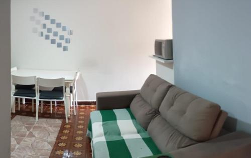 a living room with a couch and a table at Apart Hotel Copacabana in Rio de Janeiro