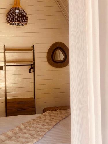 a bedroom with a bed and a window and a mirror at lumbung asmara in Singaraja