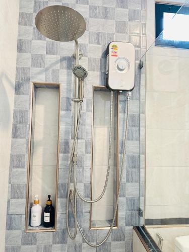 a shower with a shower head in a bathroom at Khaosok Sunset Resort in Khao Sok National Park