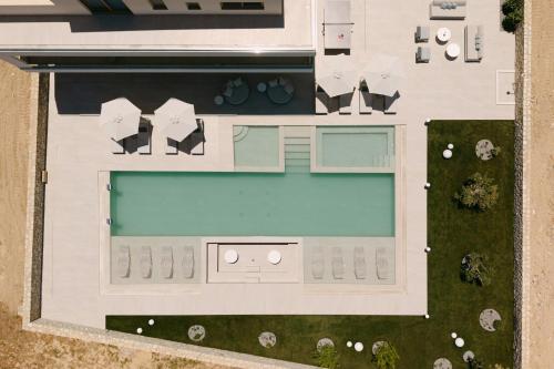 an overhead view of a house with a swimming pool at Calòre Villa, Close to Beach, Gym, Sauna & Cinema, By ThinkVilla in Pigianos Kampos