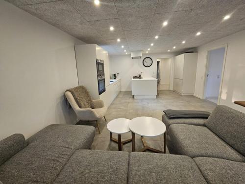 a living room with a couch and chairs and a table at Modern marina 