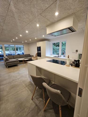 a kitchen and living room with a counter and chairs at Modern marina 