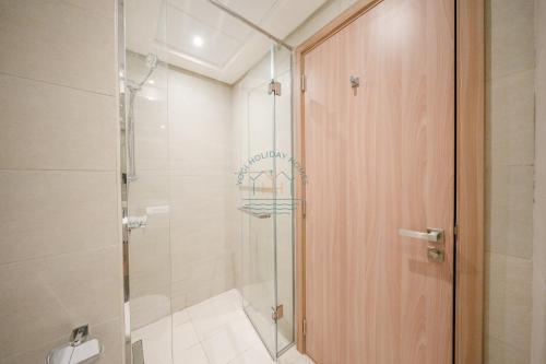 a bathroom with a shower and a glass door at Yogi - Studio in Azizi Riviera - MBR City & Pool in Dubai