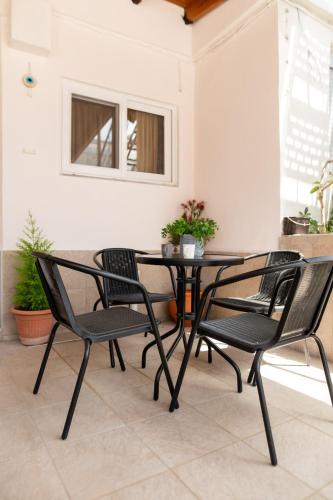 a black table and chairs on a patio at Nerida Beach Apartment in Lampi