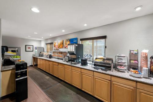 a large kitchen with a large counter with food at Comfort Inn Gaslamp Convention Center in San Diego