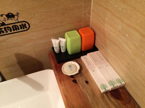 a wooden shelf next to a toilet in a bathroom at Tourist Courtyard Hotel in Jianchuan
