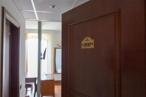 a door with a sign on it in a room at Best Western Hotel Santa Caterina in Acireale