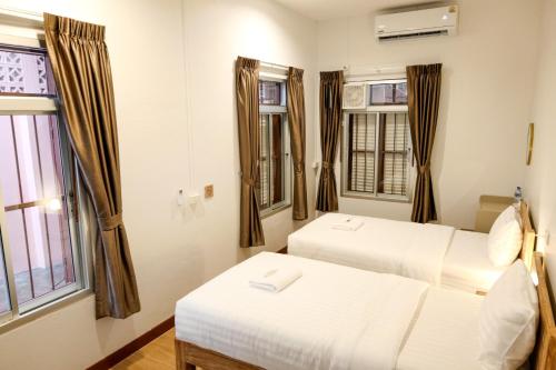 Ένα ή περισσότερα κρεβάτια σε δωμάτιο στο Au samlor guesthouse