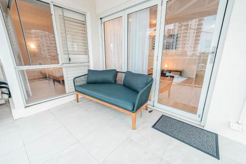 a green chair sitting on top of a balcony at Maroochydore Coastal Suite in Maroochydore