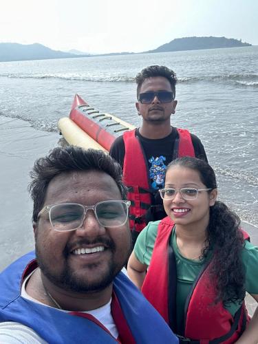 two men and a woman on a boat in the water at Arabian sea camping in Alibag