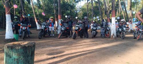 a group of motorcycles parked on a dirt road at Arabian sea camping in Alibag