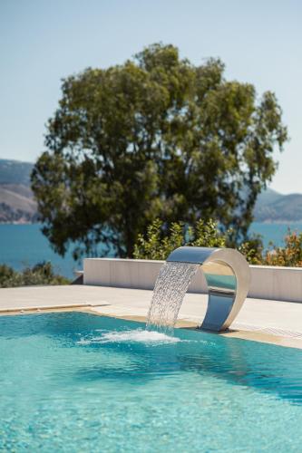 a water fountain in a swimming pool at Remenata in Lixouri