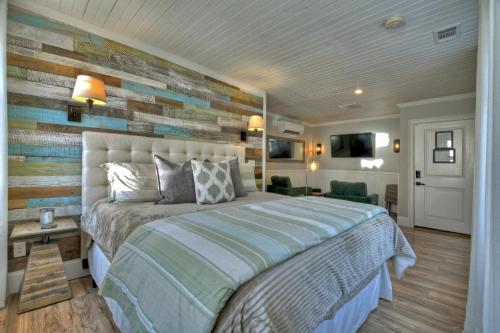 a bedroom with a bed and a wall of wood at The Penthouses on Main - Downtown Blue Ridge in Blue Ridge
