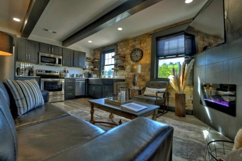 a living room with a couch and a table at The Penthouses on Main - Downtown Blue Ridge in Blue Ridge