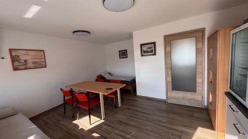 a room with a table and chairs and a bed at Bergland Top 4-1 in Petzenkirchen