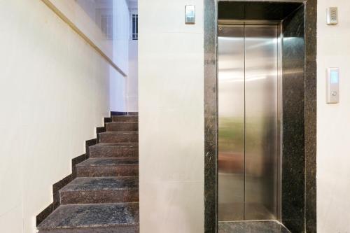 a staircase with a metal elevator in a building at Wandr Hotel Brookefield, Bangalore in Bengaluru