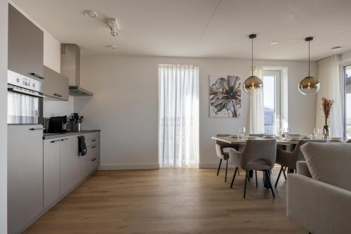 a kitchen and dining room with a table and chairs at Apartment Havenzicht 10B Kortgene in Kortgene
