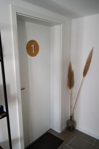 a hallway with a clock on the wall at Apartment 67 in Bad Neustadt an der Saale