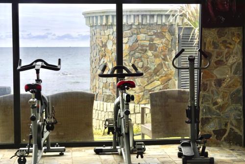 two bikes parked in front of a window with the ocean at Edensee Kega Beach Resort in Ke Ga