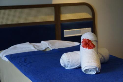 a pair of rolled up towels on a bed at Edensee Kega Beach Resort in Ke Ga