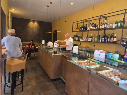 two people sitting at a counter in a restaurant at suebi rooms and appartament in Termoli