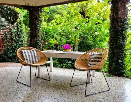 a table with two chairs and a table with flowers at Gaestehaus ESSENCE 