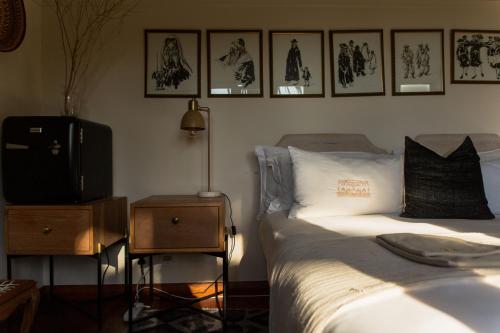 a bedroom with a bed and a tv on a table at Sonnekus Boutique Hotel & Bistro in Kalk Bay