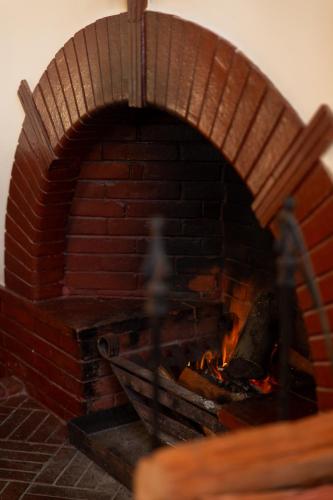 a brick oven with a fire in it at Sonnekus Boutique Hotel & Bistro in Kalk Bay