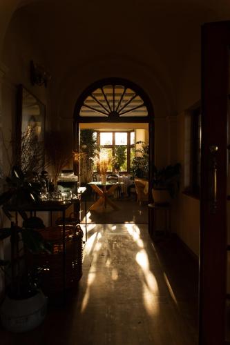 a living room with an archway and a table in a room at Sonnekus Boutique Hotel & Bistro in Kalk Bay