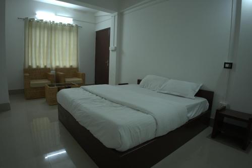 a bedroom with a large bed in a room at Traveller's Hostel by Spirit of Adventure, Dirang in Dirang Dzong