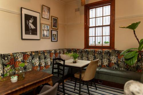 a waiting room with a table and a couch at Sonnekus Boutique Hotel & Bistro in Kalk Bay