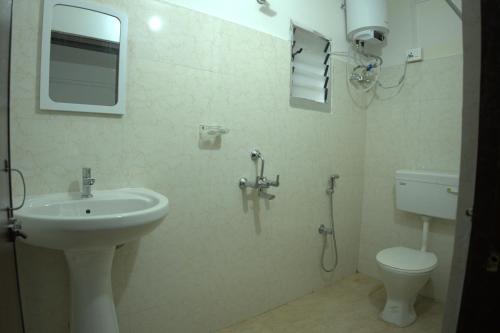 a bathroom with a sink and a toilet at Traveller's Hostel by Spirit of Adventure, Dirang in Dirang Dzong