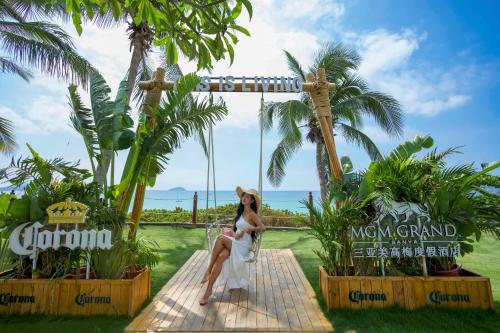 a woman sitting on a swing at a resort at MGM Grand Sanya in Sanya