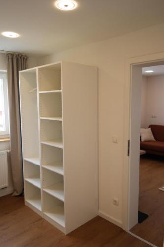 a white closet with shelves in a room at Apartment 67 in Bad Neustadt an der Saale