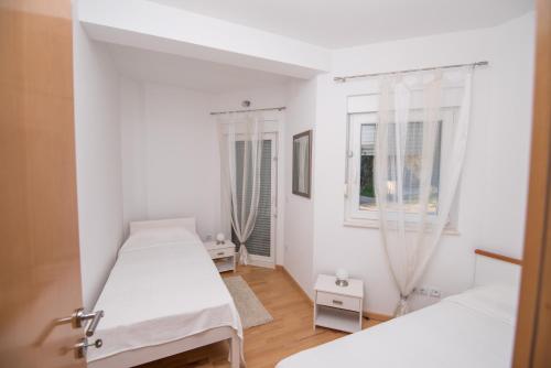 Postel nebo postele na pokoji v ubytování Villa Diva Apartments