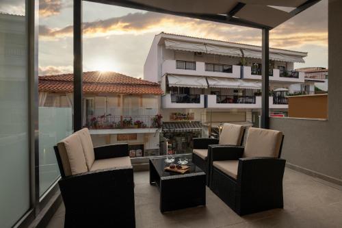 a balcony with chairs and a view of a building at Villa Paraschou in Neos Marmaras