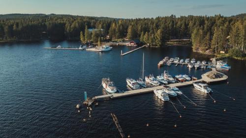 an aerial view of a dock with boats in the water at Sahanlahti Resort in Puumala