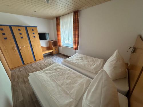 a bedroom with two beds and a window at Pension Werre Stern in Bad Oeynhausen