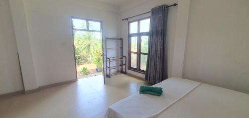 Ένα ή περισσότερα κρεβάτια σε δωμάτιο στο Hill house mirissa