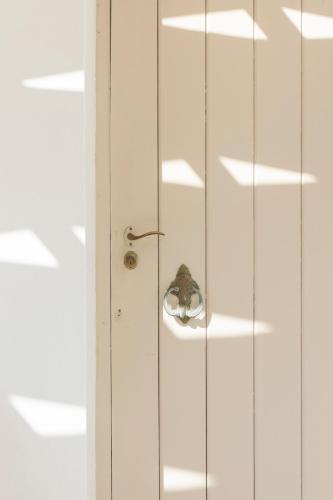 a small butterfly is sitting on a door knob at SPITIA VASILI in Kapsálion