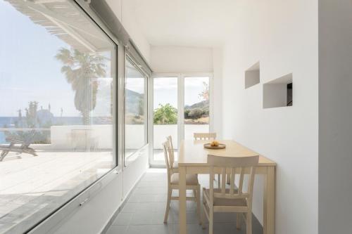 a dining room with white walls and a table and chairs at SPITIA VASILI in Kapsálion