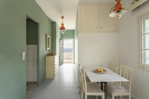 a kitchen with a table and chairs in a room at SPITIA VASILI in Kapsálion