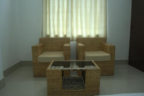 a living room with two chairs and a table at Traveller's Hostel by Spirit of Adventure, Dirang in Dirang Dzong