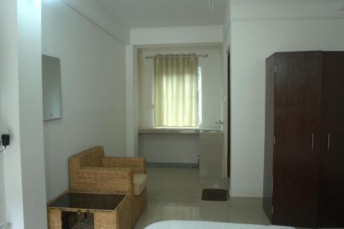 a living room with a chair and a window at Traveller's Hostel by Spirit of Adventure, Dirang in Dirang Dzong