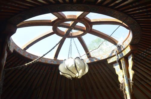 a chandelier hanging from a ceiling in a building at Le portillon des fées in Sost
