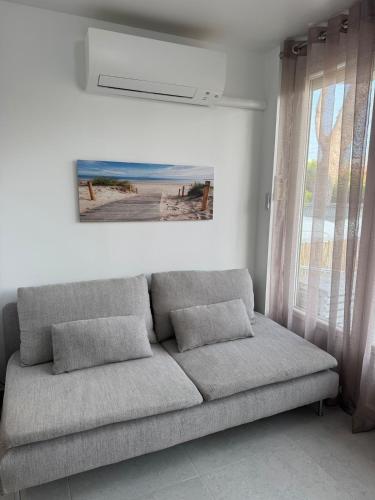 - un canapé dans le salon orné d'une peinture murale dans l'établissement magnifique T2 calme bord de mer, à La Ciotat