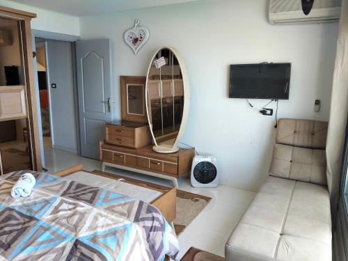 a living room with a bed and a mirror at Gleem Luxury Condo Direct Sea view G18 in Alexandria