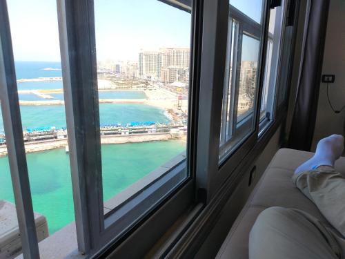 a room with a window with a view of the ocean at Gleem Luxury Condo Direct Sea view G18 in Alexandria