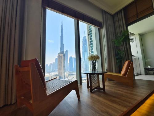 a living room with a view of a city at Downtown Views 2 - Burj Khalifa View in Dubai